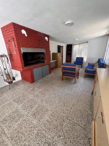 a living room with a red brick fireplace at CaSaBELLa in La Floresta +3 photos