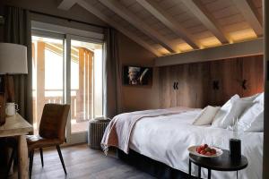 a bedroom with a bed and a table with a plate of fruit on it at Chalet Le Prariand - Megève in Megève
