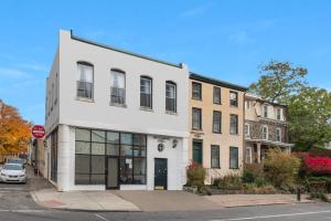 a white building on a street with a stop sign at Historic Germantown 1br Loft in Philadelphia