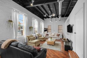 a living room with a leather couch and chairs at Historic Germantown 1br Loft in Philadelphia