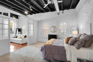 a bedroom with a large bed and a fireplace at Historic Germantown 1br Loft in Philadelphia