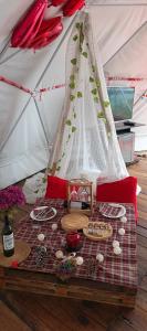 a picnic table in a tent with food on it at Glamping Eco Azulejo in Arbeláez