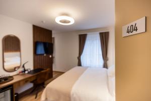 Krevet ili kreveti u jedinici u okviru objekta Deluxe Appart & Hotel Zürich Kreis 4