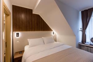 Krevet ili kreveti u jedinici u okviru objekta Deluxe Appart & Hotel Zürich Kreis 4