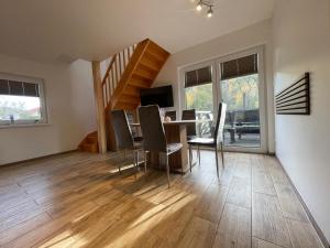 a dining room and living room with a table and chairs at Wiślańska Dolina in Wisła