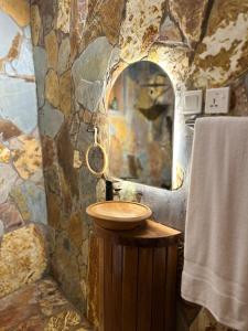 a stone bathroom with a sink and a mirror at Floating Villa near Nzulezu in Beyin +12 photos