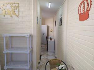 a hallway with a cactus painted on the wall at Pousada - Flat - Kitnet - Mobiliada, Confortável e Perto de Tudo in Atibaia