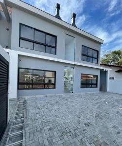 a large white house with a lot of windows at Apartamento em Itajuba - Barra Velha 120m do mar in Barra Velha