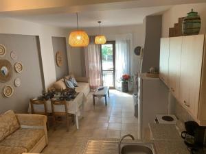 a living room with a couch and a table at Christina's Seaside in Lefokastro