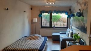 a living room with a bed and a couch and a window at 2 Zimmer, Bad ohne Küche in Jesberg