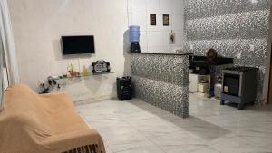 a living room with a fireplace and a tv at Casa na Ilha de Itamaraca in Vila Velha