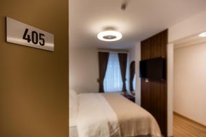 Krevet ili kreveti u jedinici u okviru objekta Deluxe Appart & Hotel Zürich Kreis 4