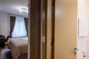 Krevet ili kreveti u jedinici u okviru objekta Deluxe Appart & Hotel Zürich Kreis 4