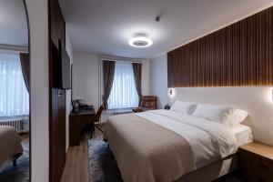 Krevet ili kreveti u jedinici u okviru objekta Deluxe Appart & Hotel Zürich Kreis 4