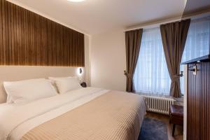 Krevet ili kreveti u jedinici u okviru objekta Deluxe Appart & Hotel Zürich Kreis 4