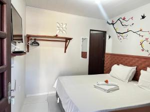 Cama ou camas em um quarto em Pousada Paraíso dos Milagres