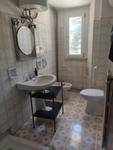 a bathroom with a sink and a toilet and a mirror at Italia Highland Retreat in Abruzzo in Verrecchie +16 photos