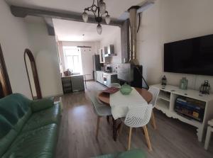 a living room with a table and a couch at Italia Highland Retreat in Abruzzo in Verrecchie