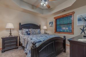 a bedroom with a bed and a ceiling fan at 2BR Village At Indian Point 503 near SDC-Free Tickets Daily up to $500 in Branson +12 photos