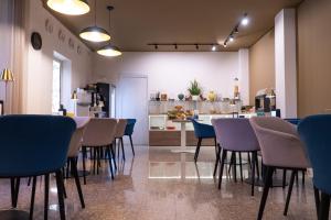 a restaurant with chairs and a table and a kitchen at Hotel Belvedere in Canicattì