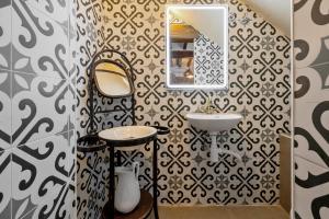 a bathroom with a sink and a mirror on a wall at La Quadra Rural Housing in Sant Carles de la Ràpita +28 photos