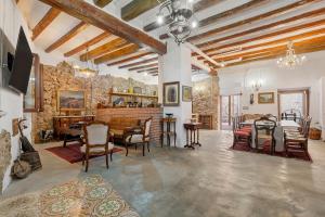 a large living room with a table and chairs at La Quadra Rural Housing in Sant Carles de la Ràpita