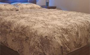 a bed with a blanket on top of it at Tiny Home Villa - T8 in San Diego