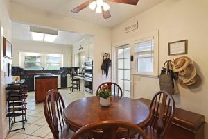 a kitchen and dining room with a wooden table and chairs at Wine Country Oasis Private Pool & Spa in Acampo