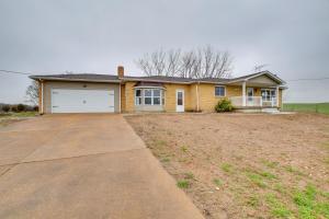 a large yellow house with a garage at Chic Ste Genevieve Home with Nice Interior Amenities in Avon