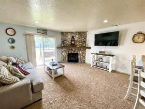 a living room with a couch and a fireplace at Beautiful Updated 2 Bedroom Condo T106 in Garden City