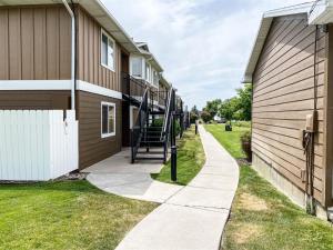 a sidewalk next to a building with a staircase at Beautiful Updated 2 Bedroom Condo T106 in Garden City