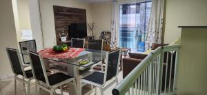 a dining room and living room with a table and chairs at Casa Lory in Angra dos Reis