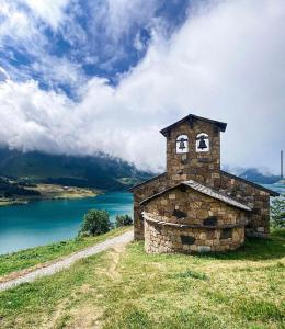 a stone oven on top of a hill with a lake at Appartement Arêches in Beaufort +13 photos