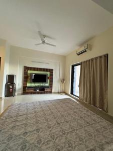 a large living room with a flat screen tv at The Chapters in Goa