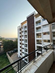 an apartment balcony with a view of a building at The Chapters in Goa
