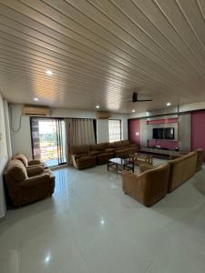 a large living room with couches and a tv at The Chapters in Goa