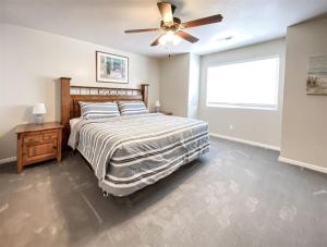 a bedroom with a bed and a ceiling fan at 14-Plex 218 in Garden City
