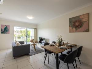a living room with a dining room table and chairs at Walk to everything Modern 2Beds Apt with Easy Access in Springwood