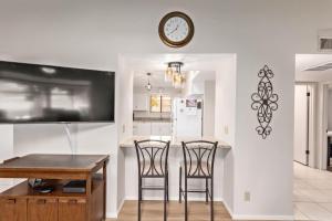 a kitchen and dining room with a clock on the wall at Relaxing 2BR plus Den Golf Retreat with Backyard and BBQ in Sun City