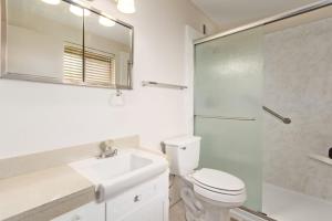 a bathroom with a toilet and a sink and a shower at Relaxing 2BR plus Den Golf Retreat with Backyard and BBQ in Sun City +26 photos