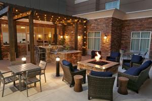 a patio with tables and chairs and a fireplace at Homewood Suites By Hilton West Fargo/Sanford Medical Center in Fargo