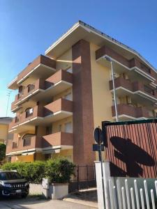 a building with a car parked in front of it at Soffio di mare in Alba Adriatica