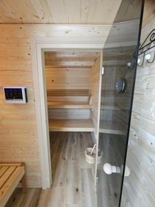 a sauna with a glass door in a wooden cabin at Blockhütte in Sankt Englmar