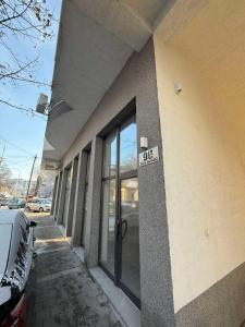 a building with a sign on the side of it at Urban Apartman-privatan parking- in Kraljevo