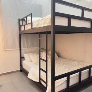 a bunk bed room with two bunk beds at Homestay Miniwaterpark 1st klate in Kampong Kelewek +9 photos