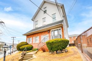 a white house with bushes in front of it at Centrally Located and Pet Friendly Yonkers Studio! in Yonkers