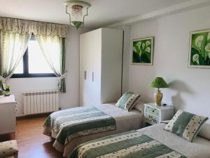 En eller flere senge i et værelse på Casa Mila