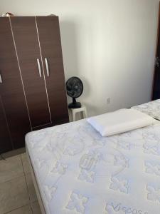 a bedroom with a bed and a dresser at Casa da Praia in Osório +8 photos