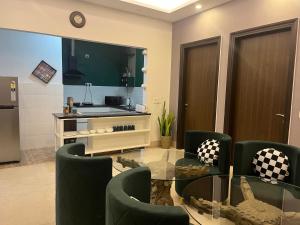 a living room with a glass table and chairs at Bed&Oats in Gurgaon