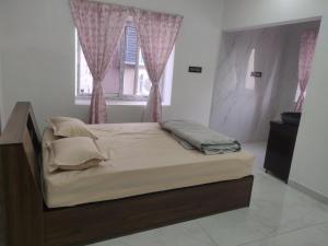 a bed sitting in a bedroom with a window at Bhoomi mansion Homestay Apartment 12 in Bhubaneshwar